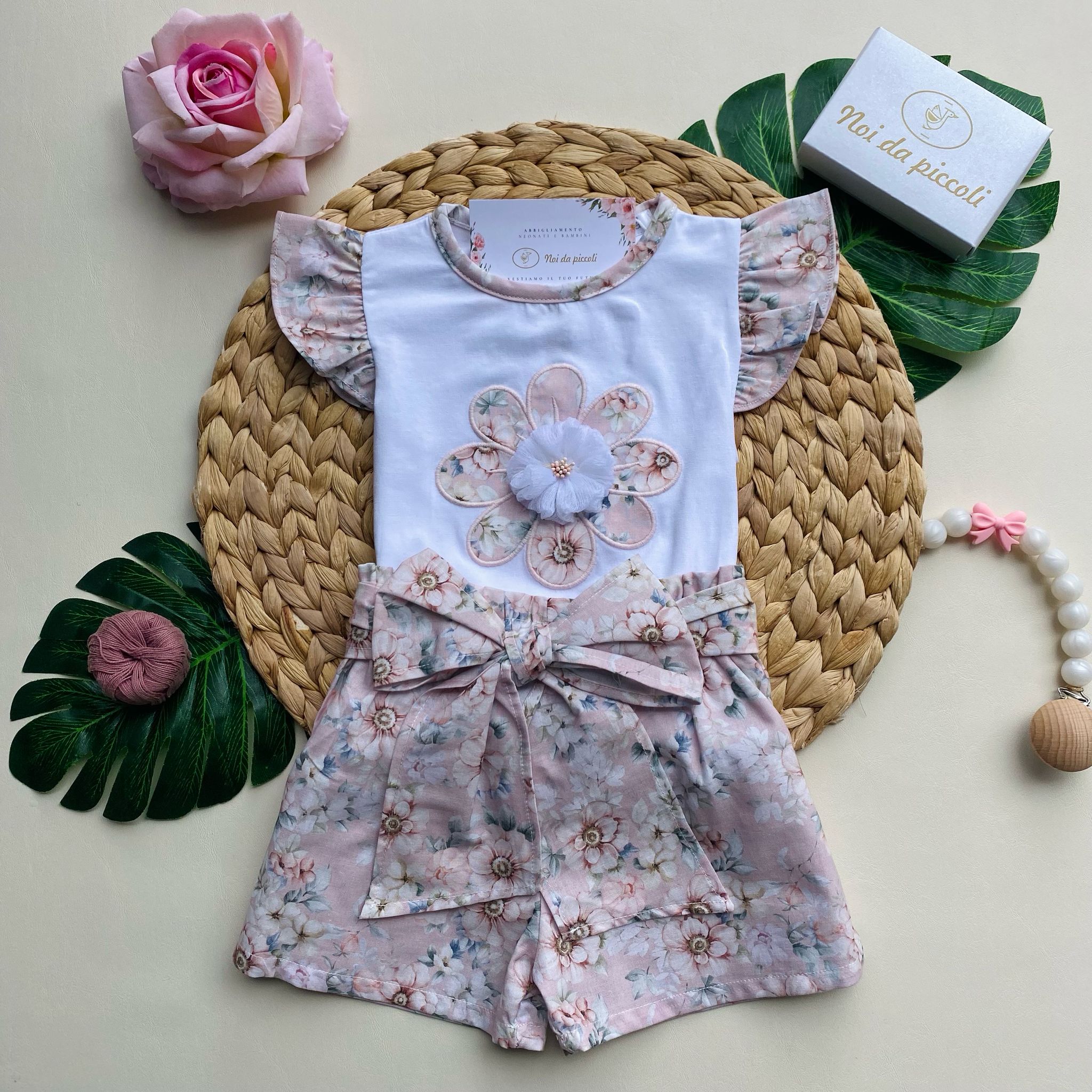 2-piece set with pink floral shorts and white t-shirt with little flowers in the center